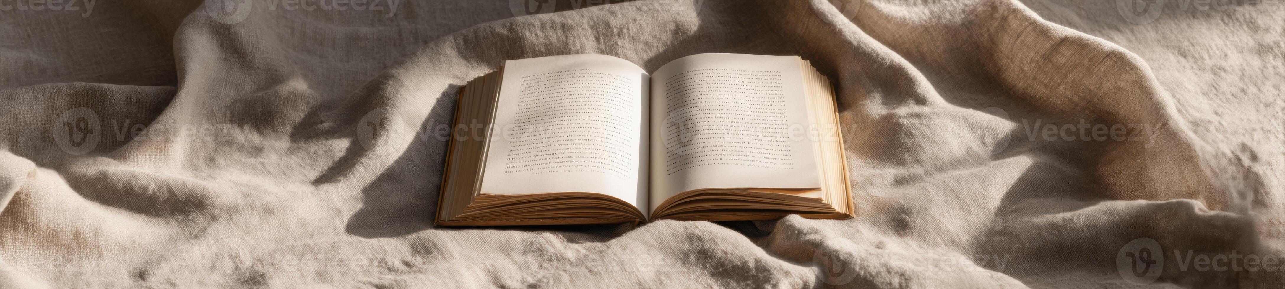 An open book is sitting on top of a brown cloth photo