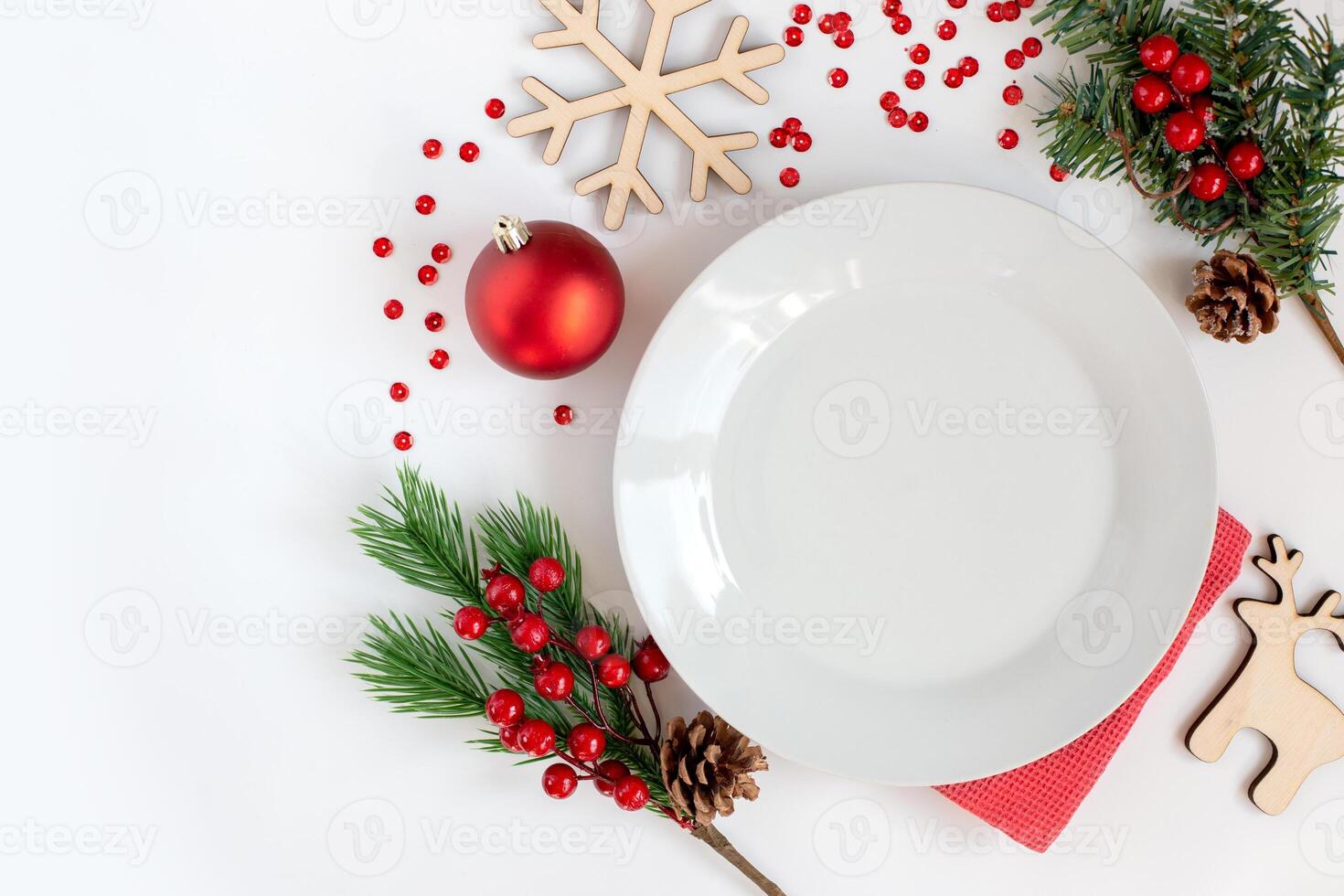 White clean round plate, on a white table with Christmas decorations photo