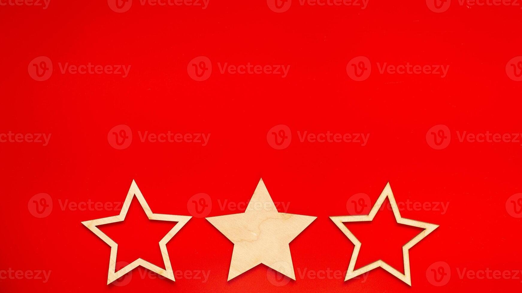 Wide banner Red background with three wooden stars at the bottom in a row photo
