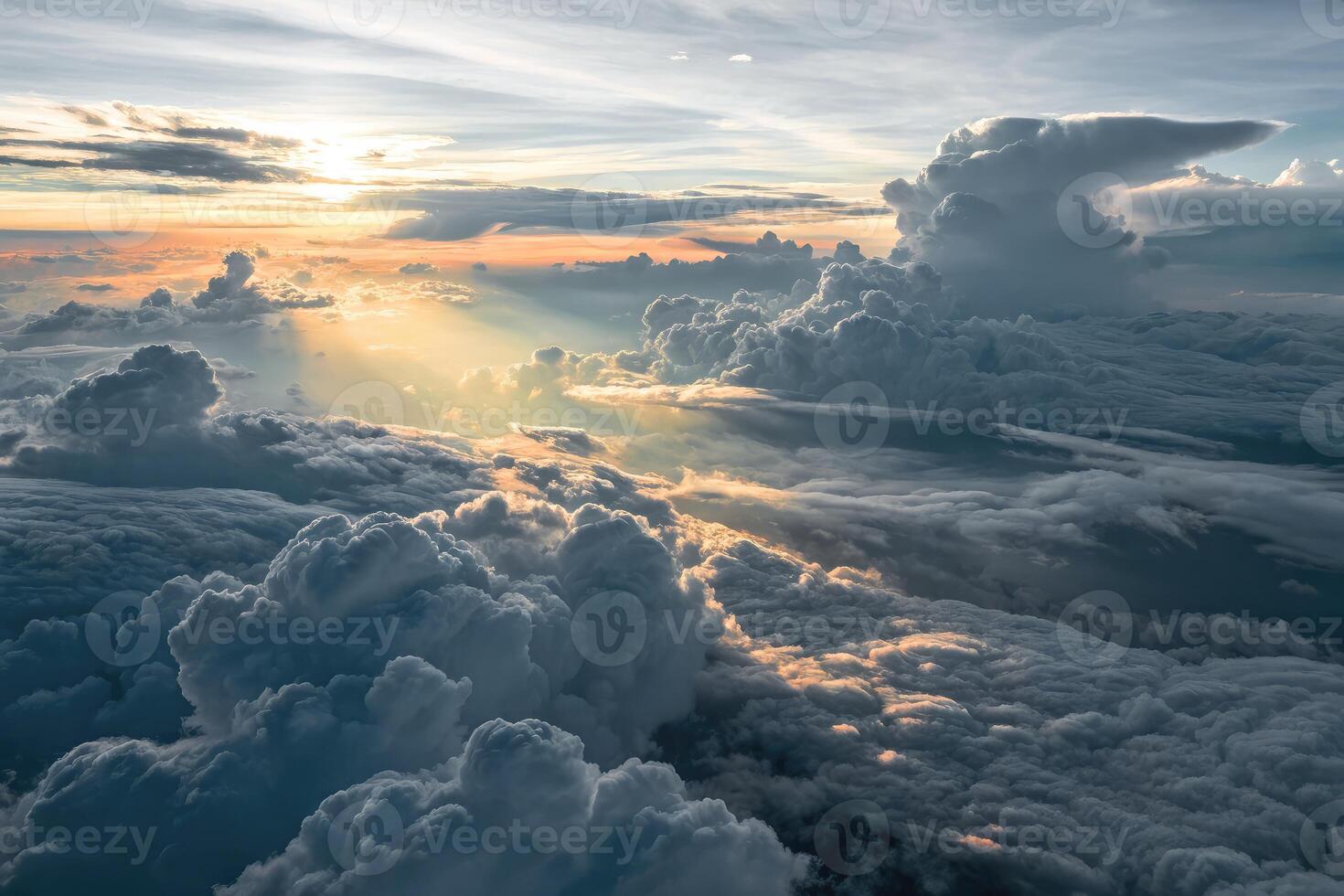 Overhead view of a massive cloud deck illuminated by low sunlight during dusk photo