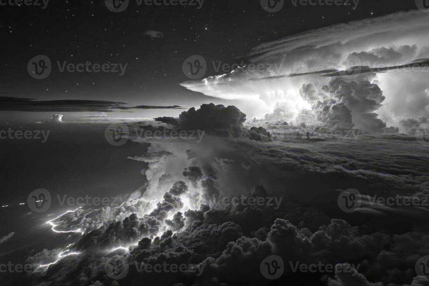 High altitude view of dark storm clouds illuminated by lightning during night photo