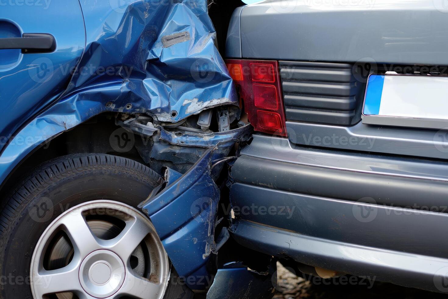 Collision between two vehicles on a city street results in damaged rear and front sections photo