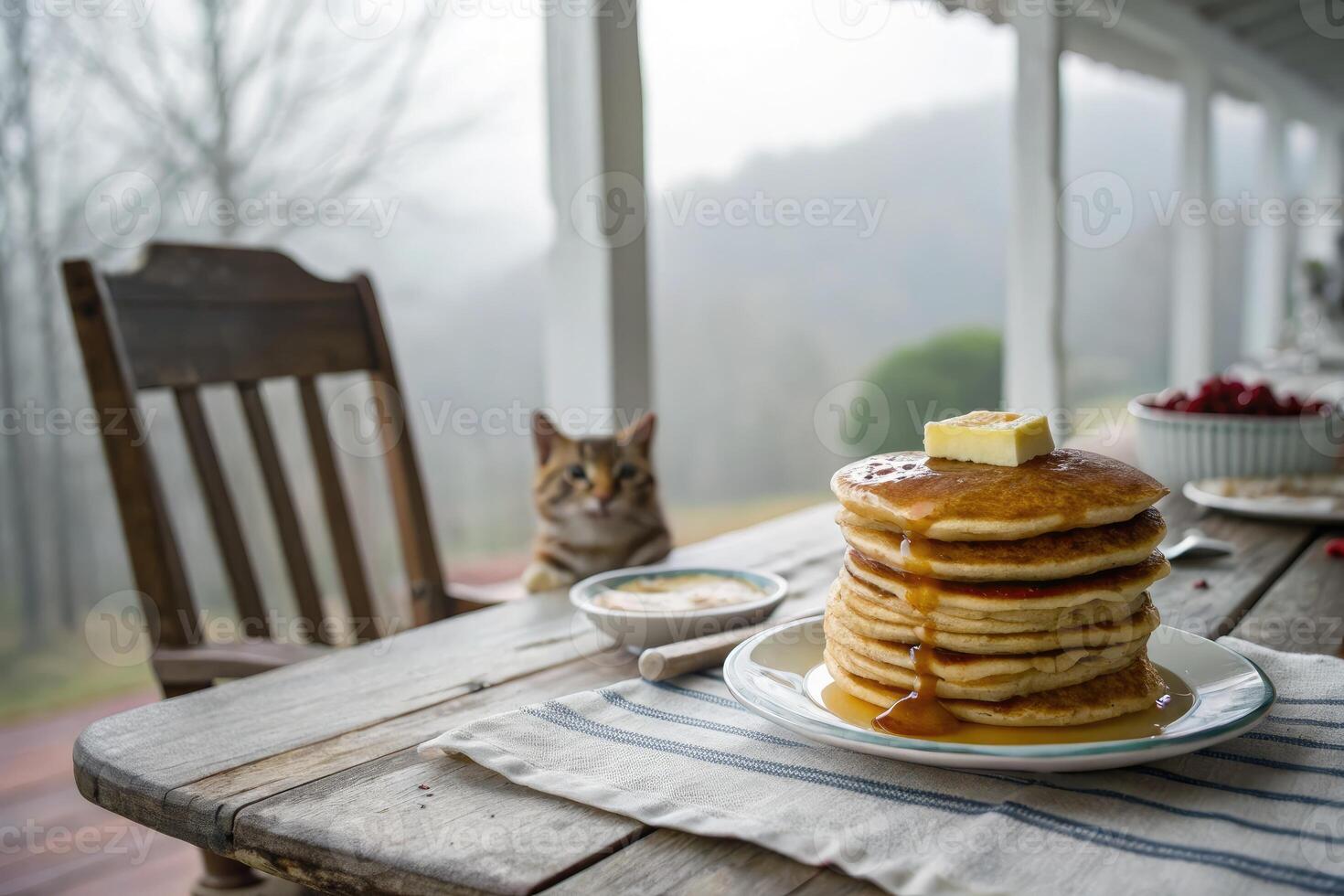 Delightful stack of pancakes with syrup and butter on a rustic farm setting in morning light photo