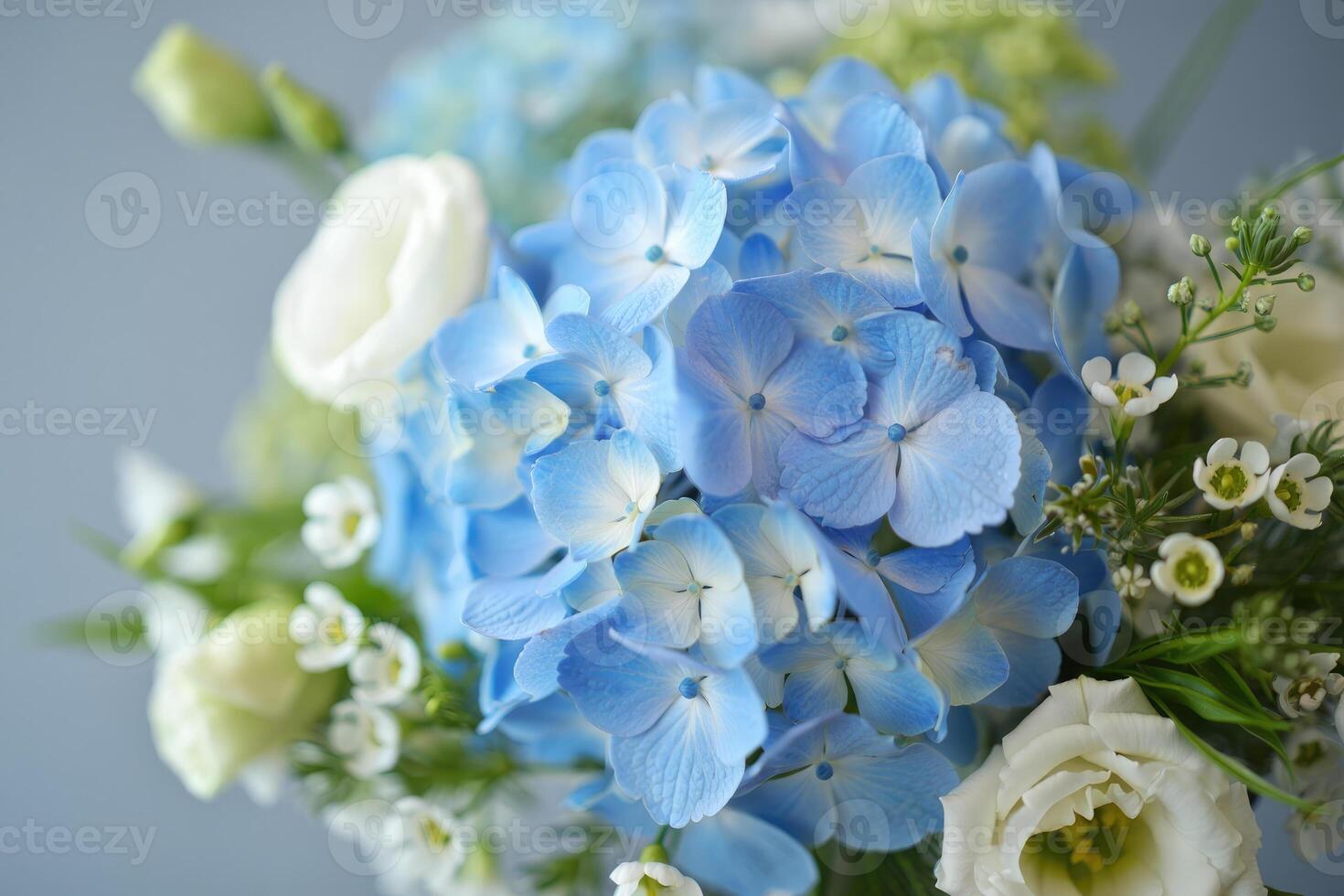 A beautiful arrangement, displaying vibrant blue hydrangeas and elegant white flowers. photo