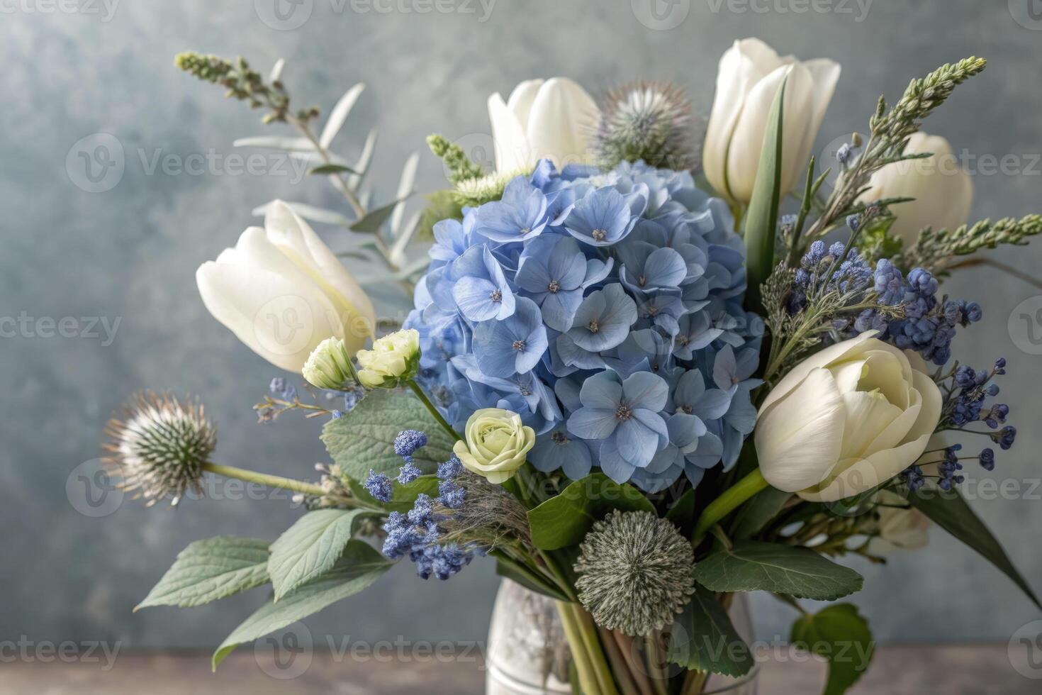 Stunning close-up view of a floral arrangement with blue hydrangeas and white tulips. photo