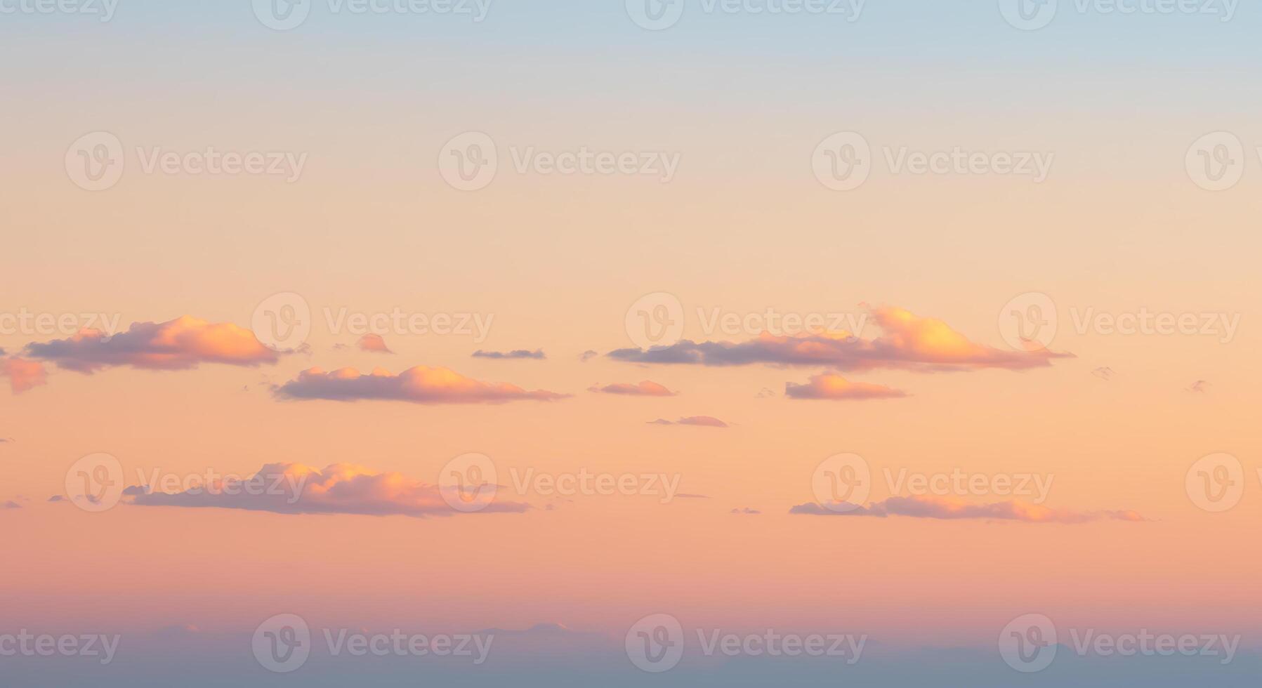 A plane flying over the ocean at sunset photo