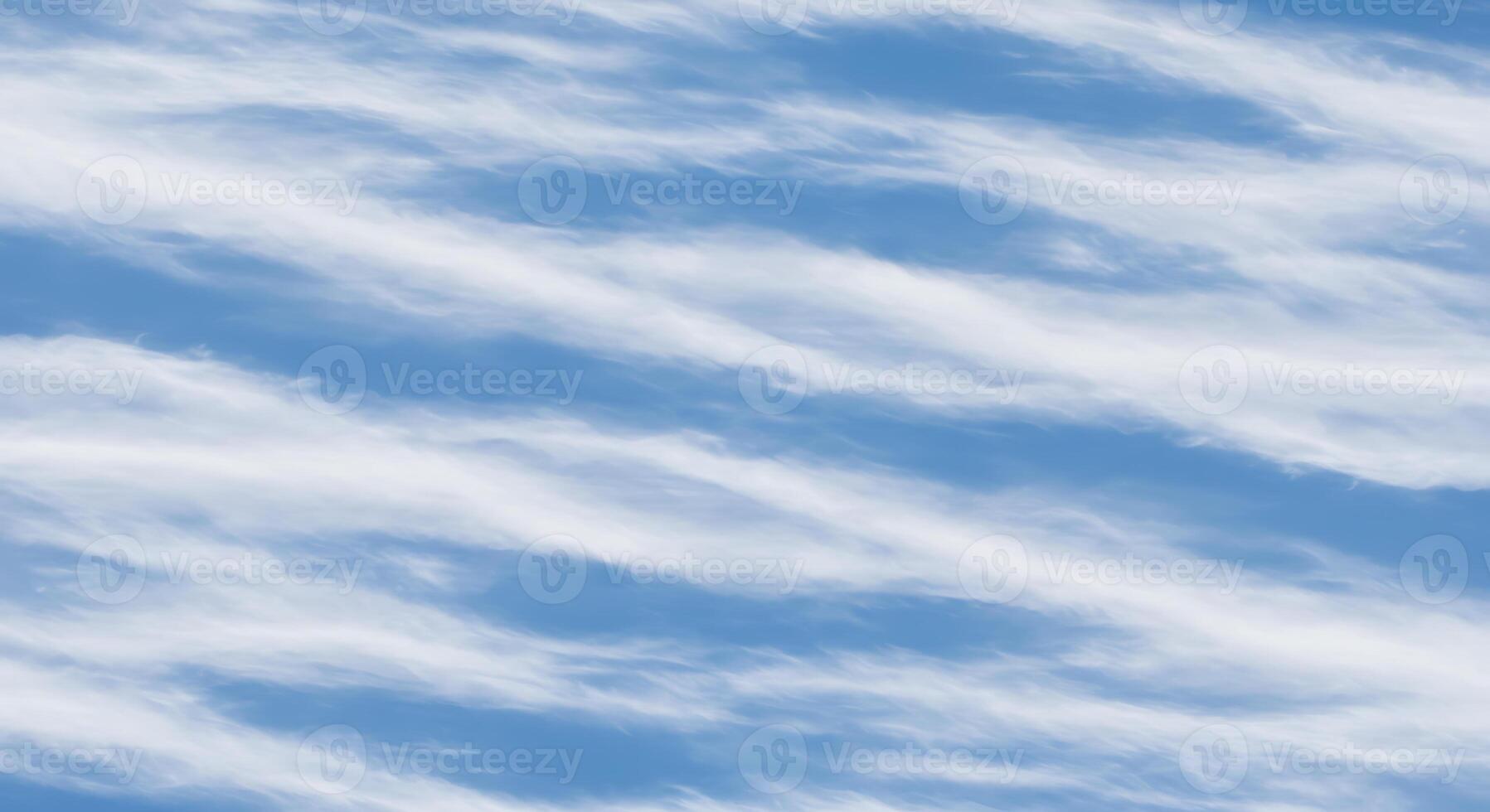 A blue sky with clouds and a plane flying in it photo