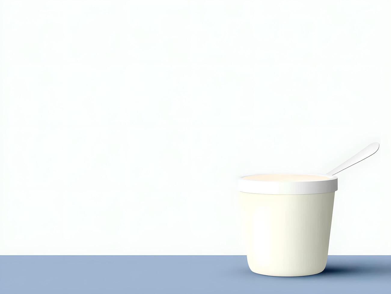 A cup of yogurt with a spoon on a table photo
