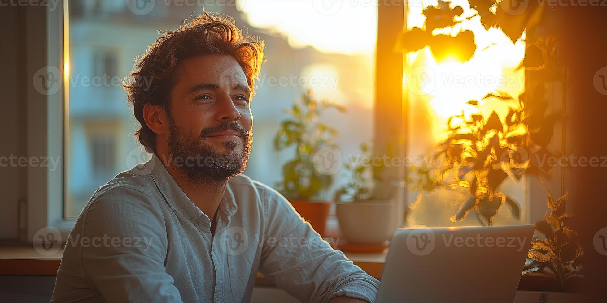 a man working on his laptop, minimalist workspace with copy space on the right, calm natural light photo