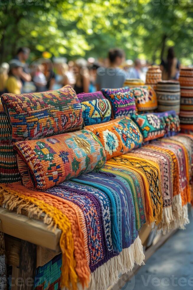 Sabantuy crafts on display, including embroidered textiles and handmade ceramics, a blurred crowd enjoying the festival in the background photo