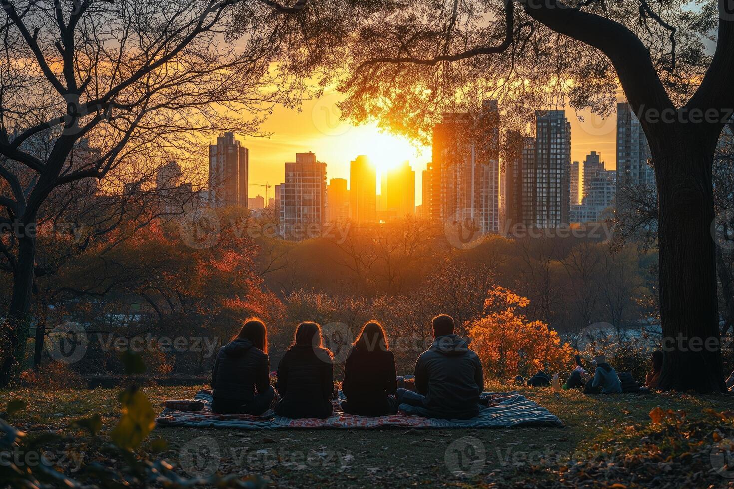 friends having a picnic in a well maintained urban green space, with vibrant city skyscrapers visible in the distance photo