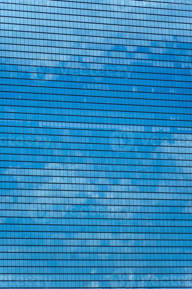 Modern building reflected sky on glass facade photo