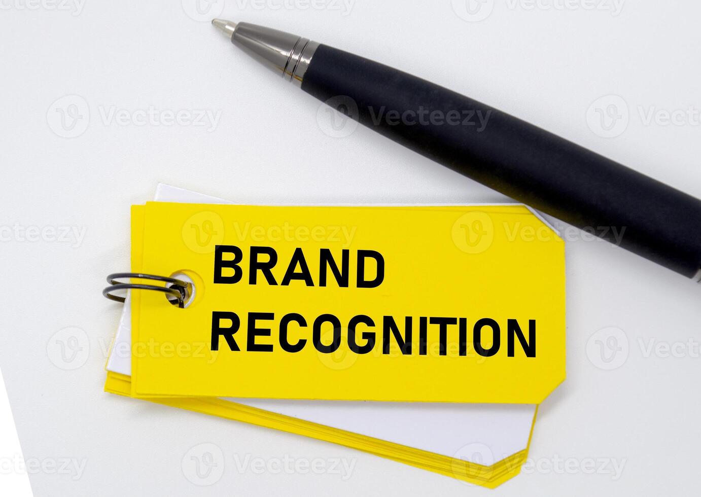 Brand recognition concept repeated on yellow sticky showing identity reinforcement and visibility. photo