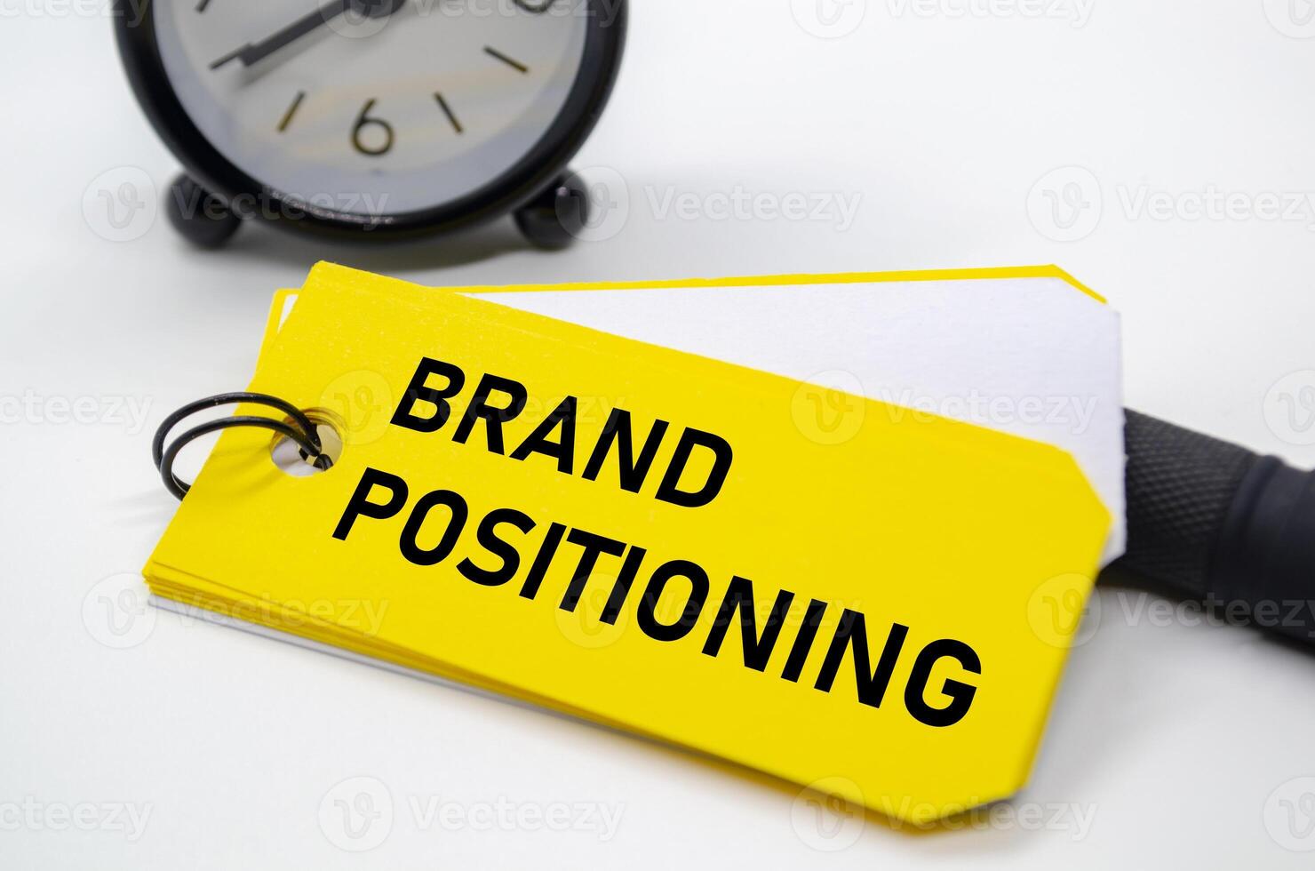 Branding positioning text in bold black font on yellow sticky note. photo