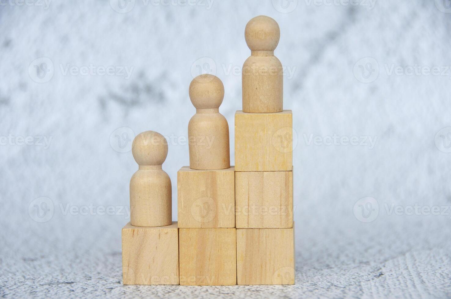 Wooden dolls on a stacking wooden cubes with customizable space for text photo