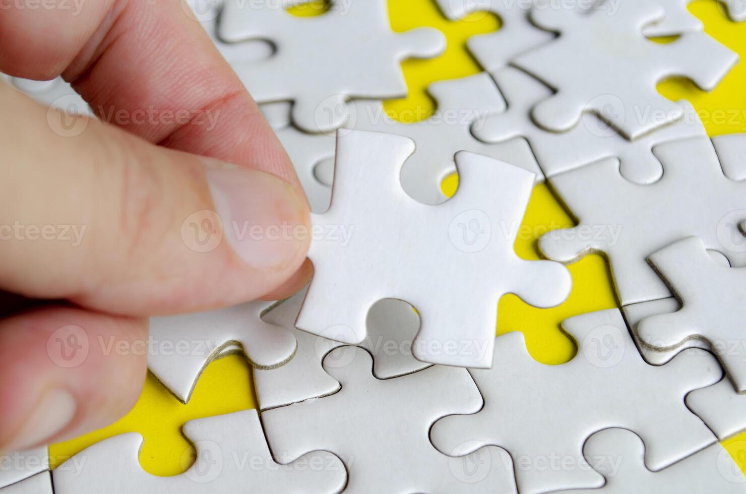 Close up of hand place missing jigsaw puzzle representing problem solving skill photo