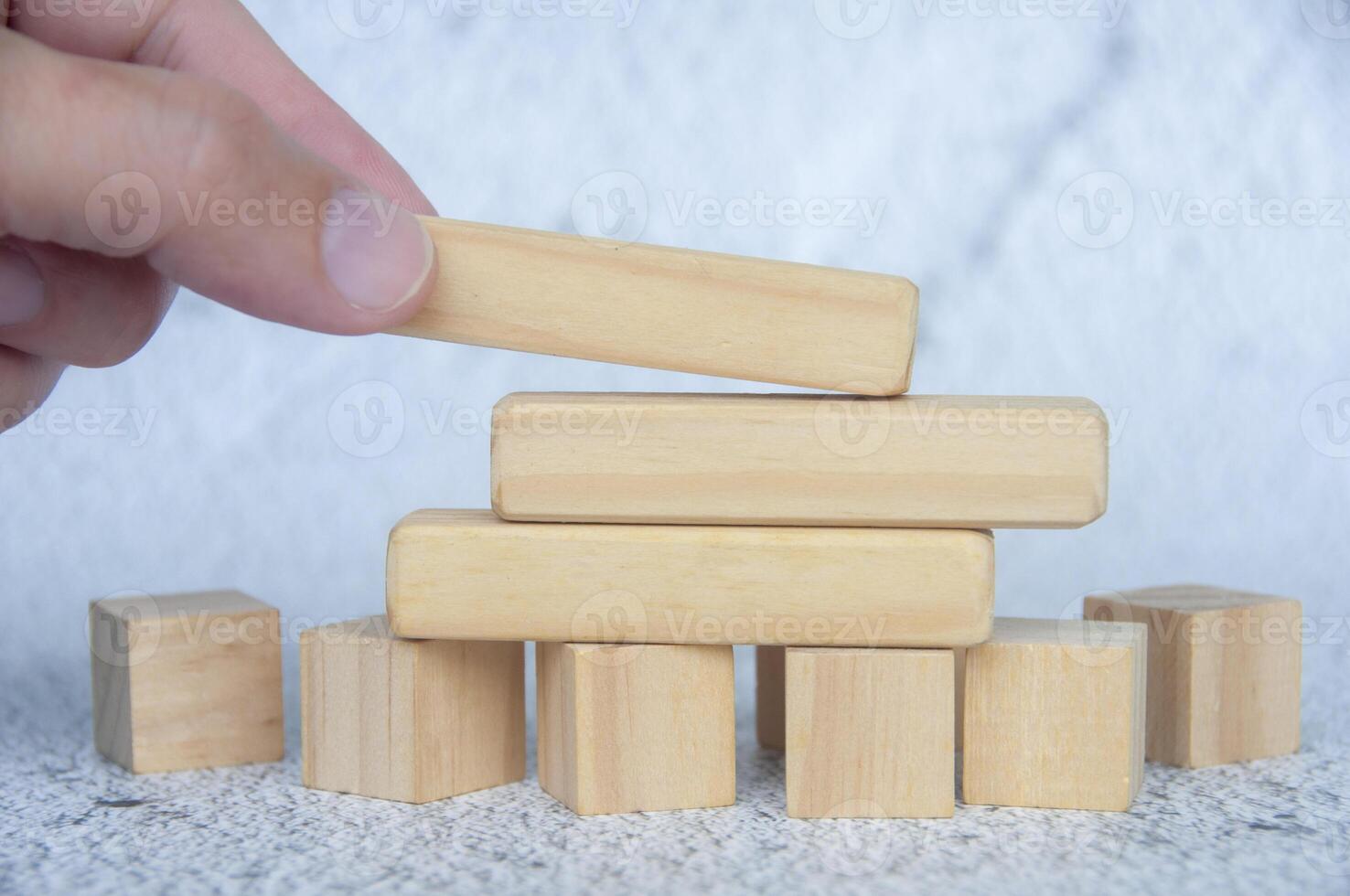 Hand placing wooden blocks with customizable space for text or ideas. Copy space concept photo