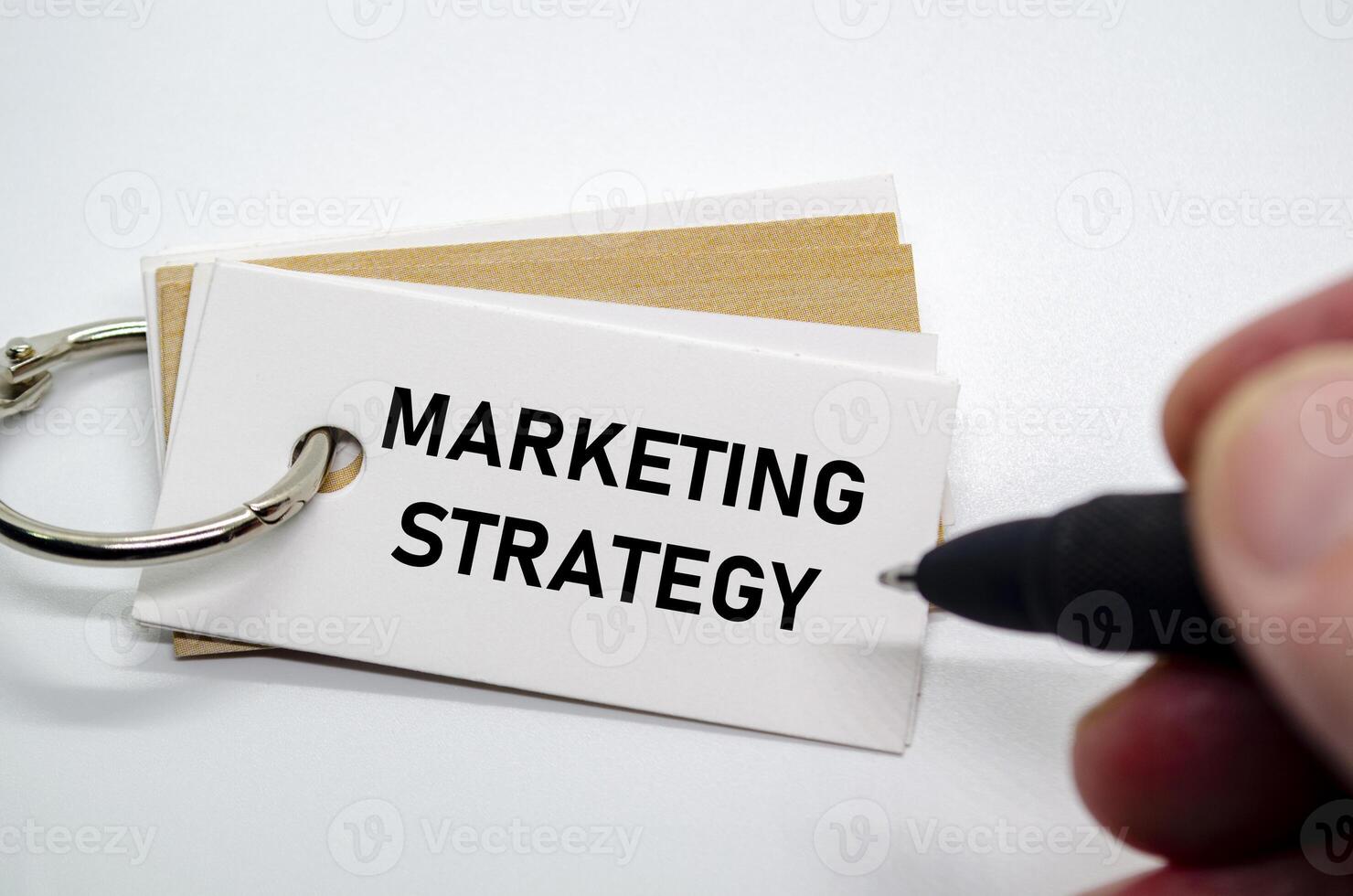 Strategic marketing plan text shown on white notepad for brand growth and audience reach. photo