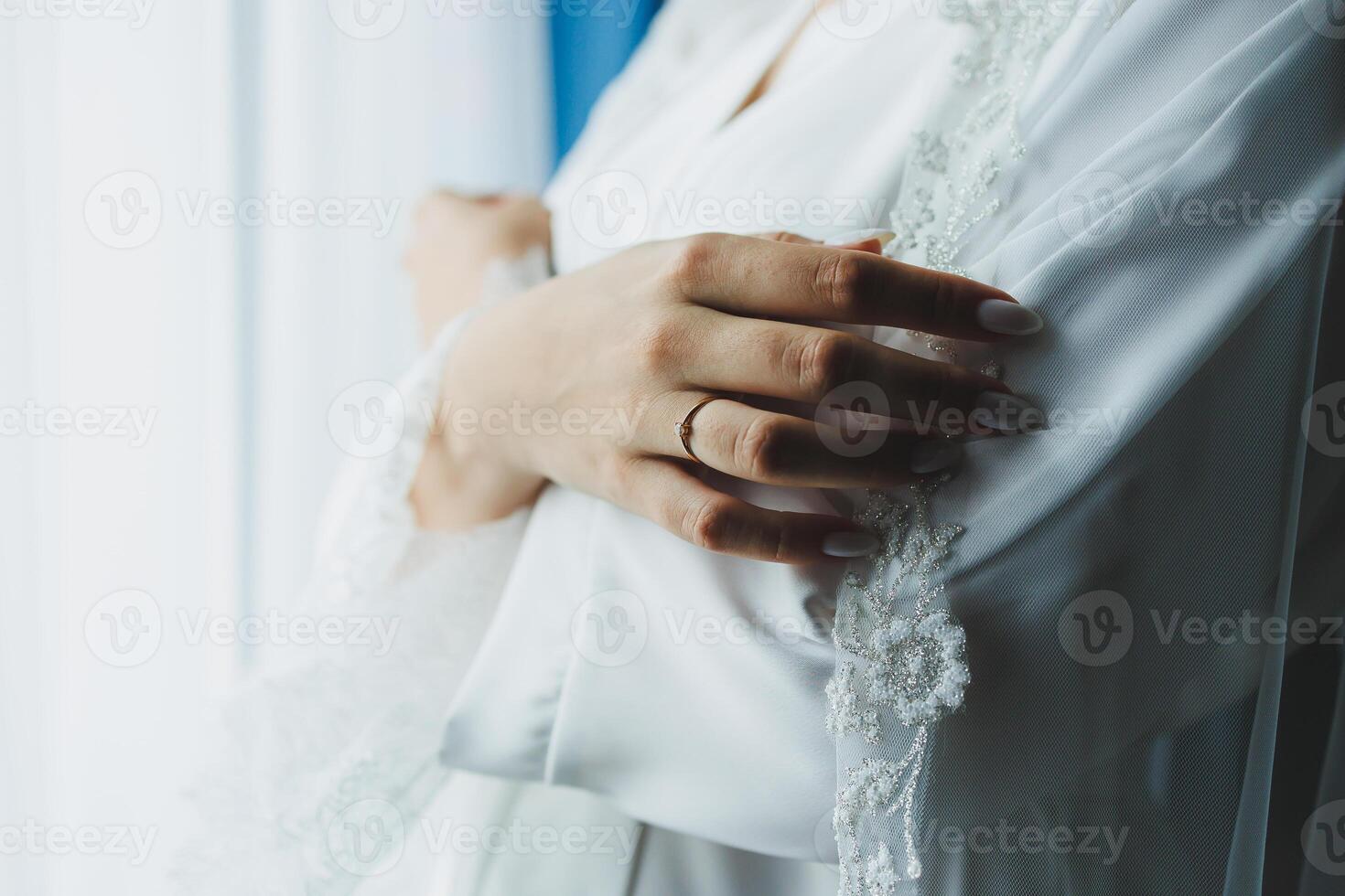 An Elegant Bride Bathed in Soft Light Surrounded by Delicate, Ethereal Fabric Accents photo