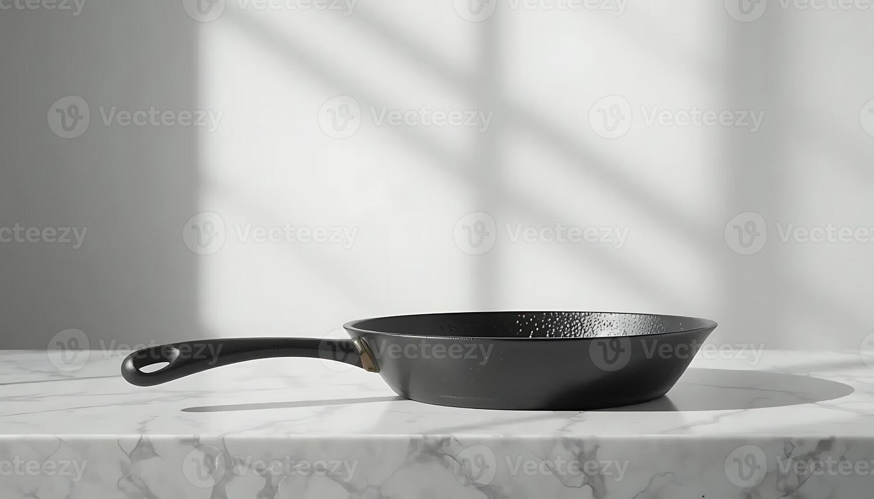 A black frying pan on a marble counter photo