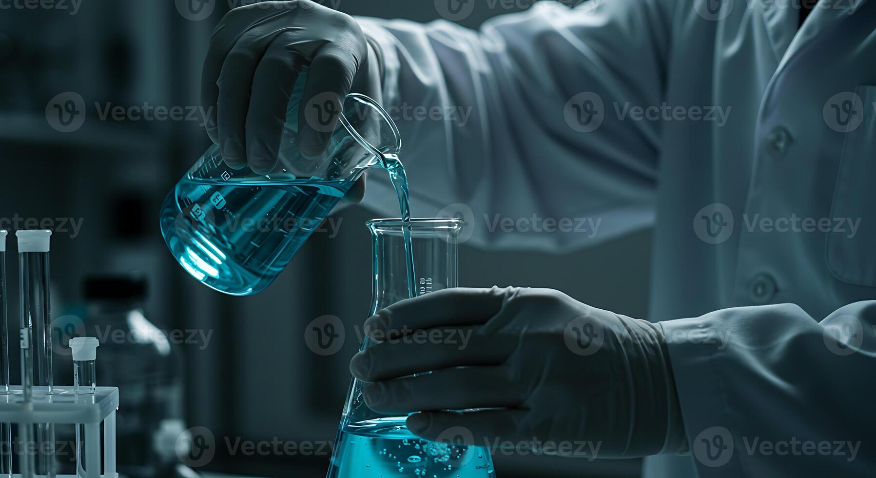A person in a lab coat pouring blue liquid into a beaker photo