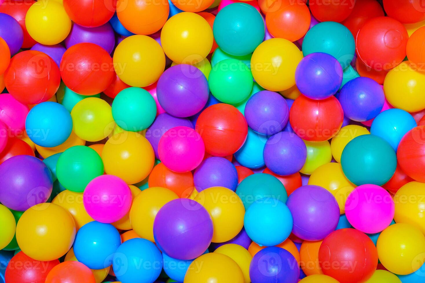 Many colorfull plastic balls in pool of game room. indoors playground. photo