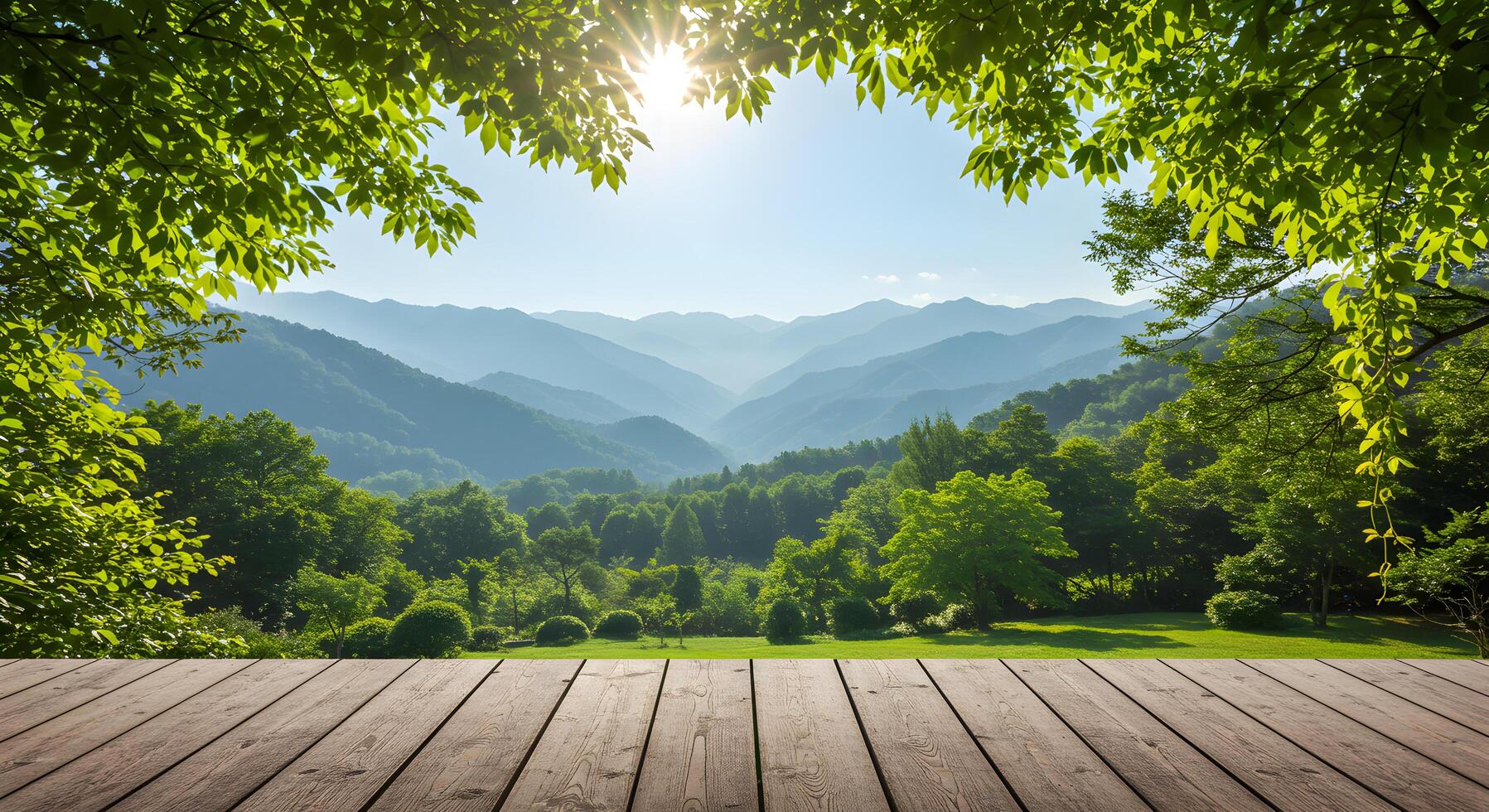 Panoramic nature vista with mountain ranges framed by lush foliage and a wooden deck photo