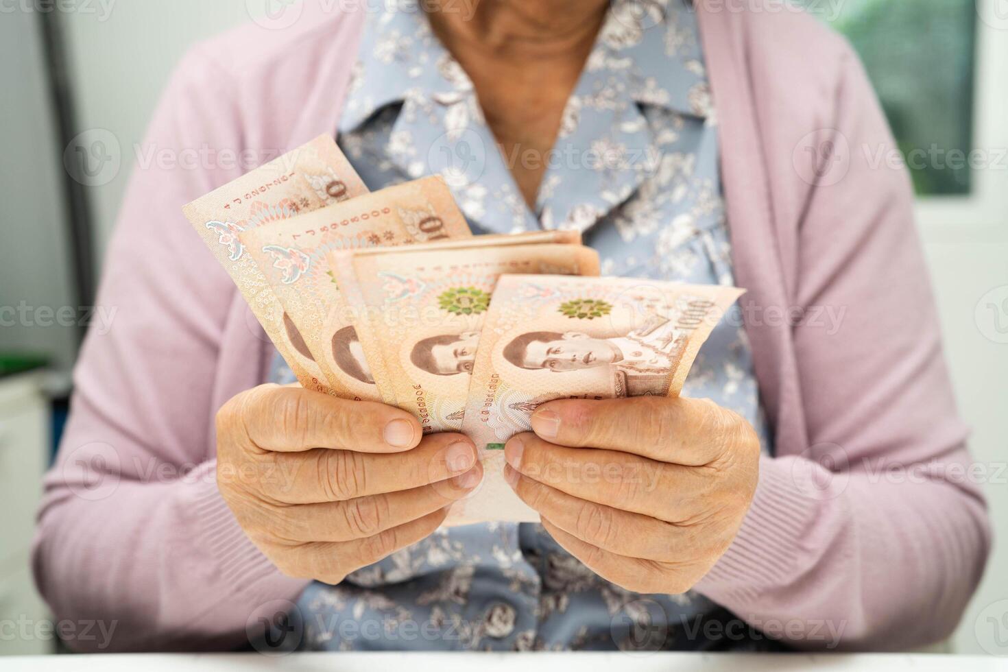 Retired elderly woman counting coins money and worry about monthly expenses and treatment fee pay photo