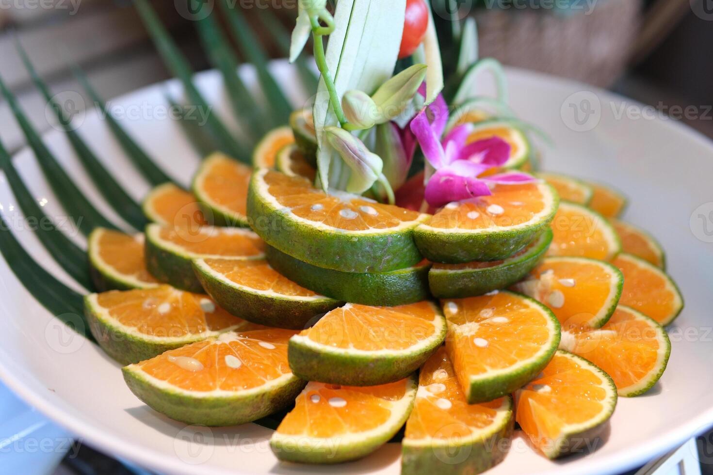 vietnamese green oranges cut on plate white beautiful decoration flowers buffet hotels restaurant photo