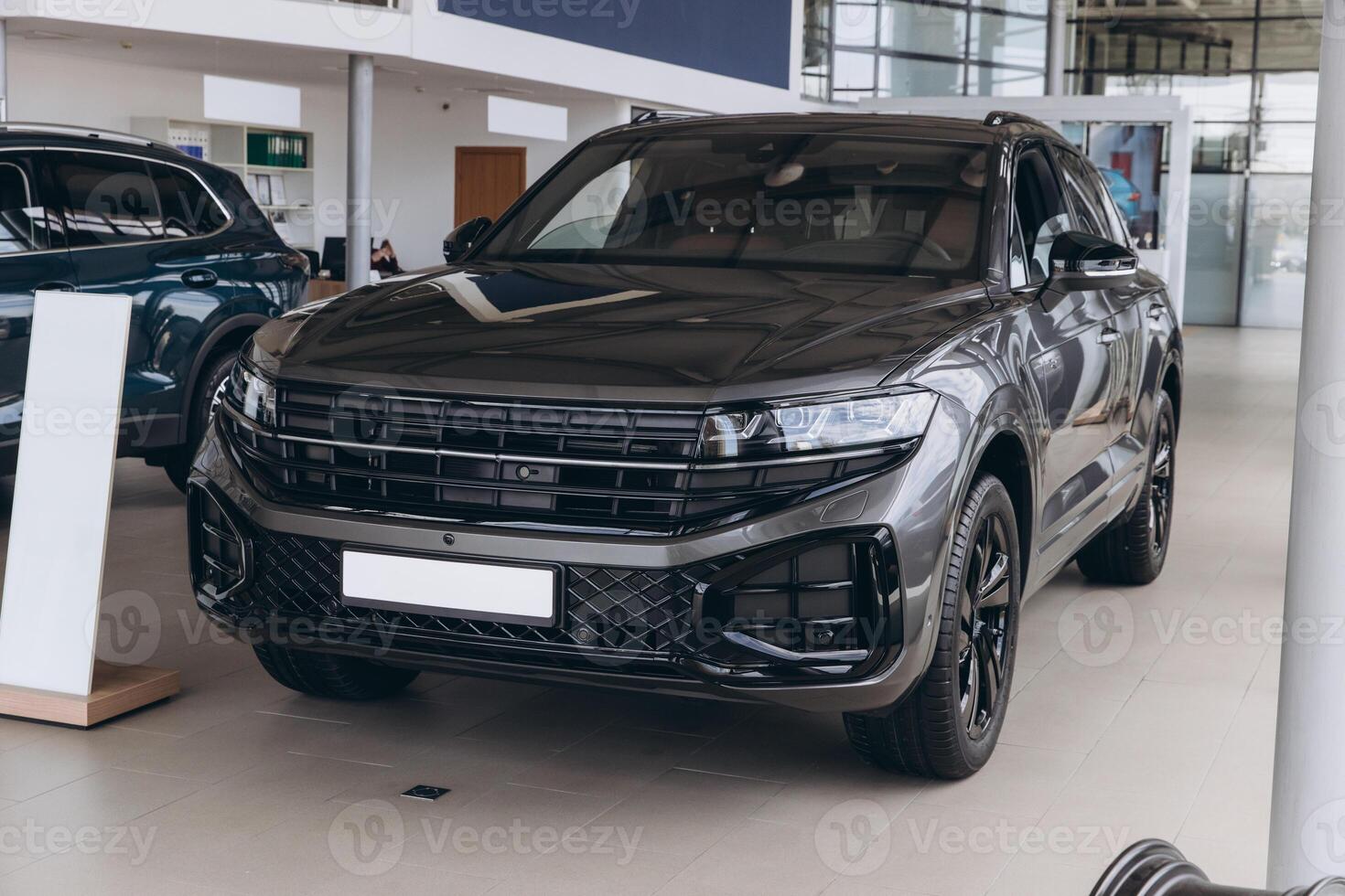 Modern SUV parked in spacious car dealership showroom, embodying luxury and innovation photo
