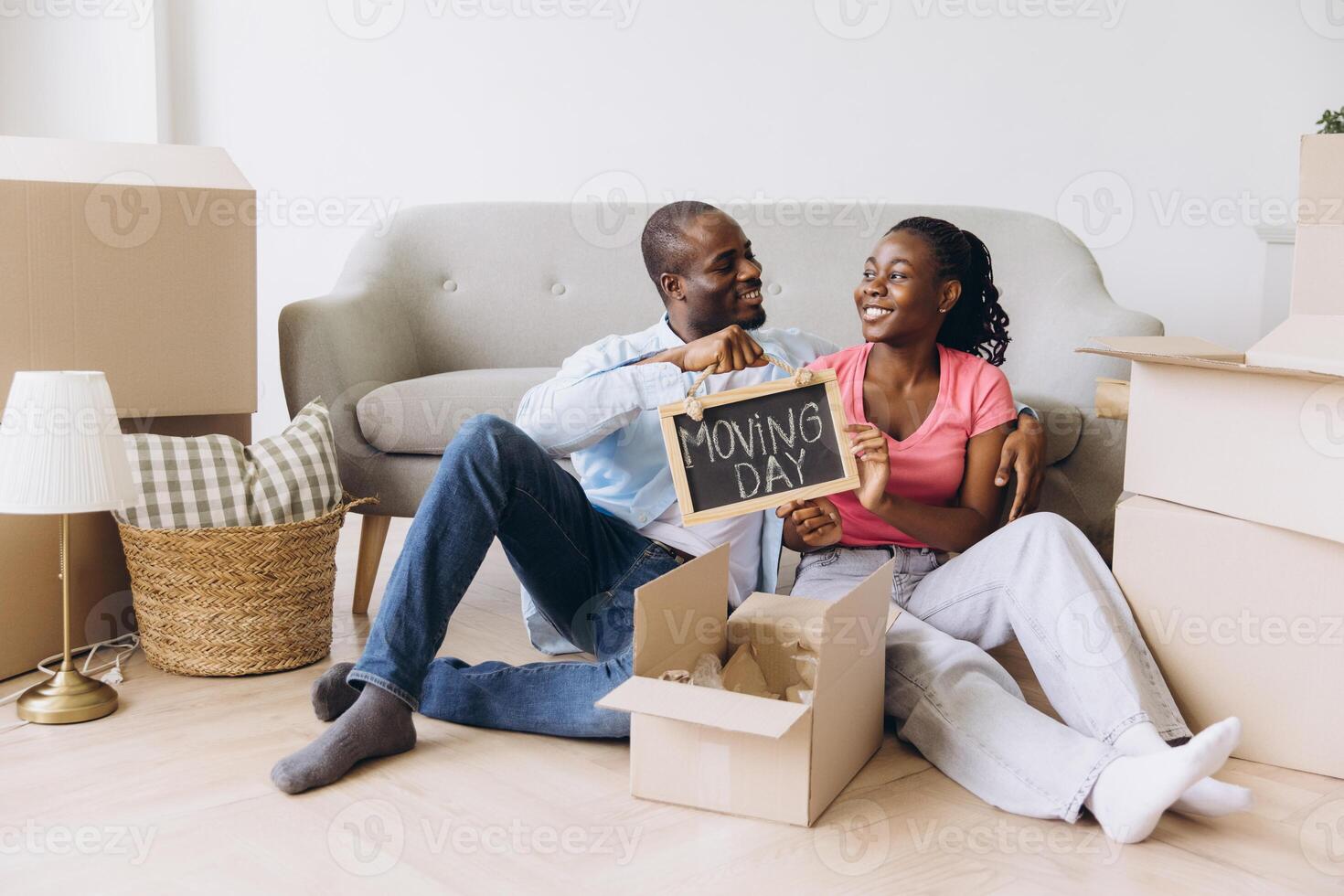 Happy Couple Celebrating Moving Day in New Home photo