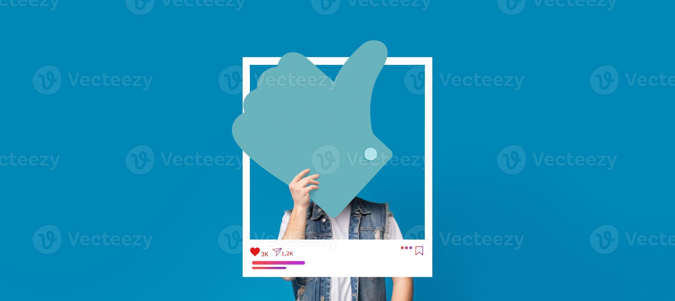 A person is interacting with a popular social media application by showing a thumbs-up gesture. The background features a vibrant blue color, perfect for creating engaging content. photo