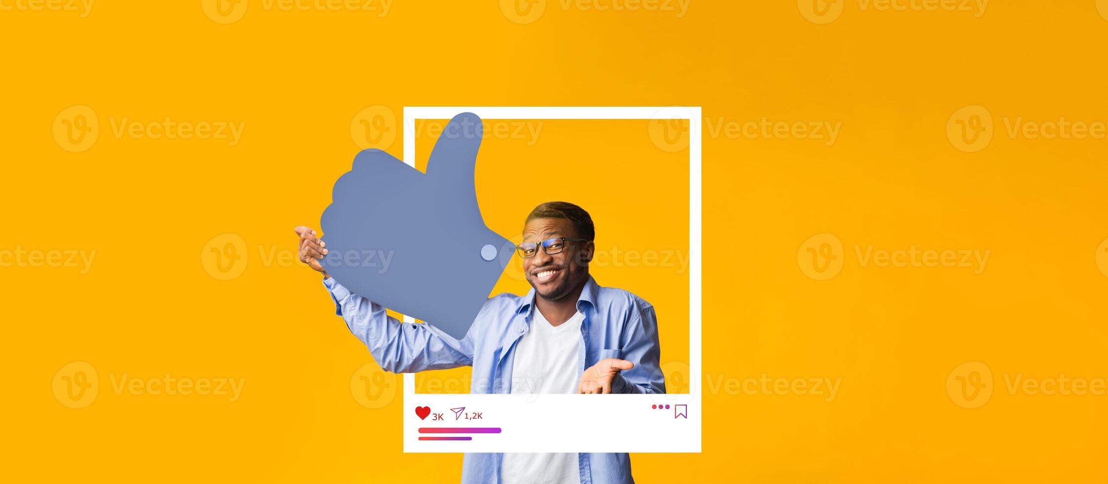 A person stands in front of a vibrant yellow background, giving a thumbs up while engaging with social media content. The individual exudes positivity, typical of online influencers. photo