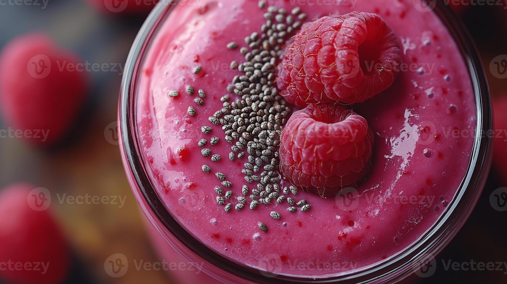 Fresh raspberry smoothie blended with chia seeds, served in a glass with raspberry garnish. photo