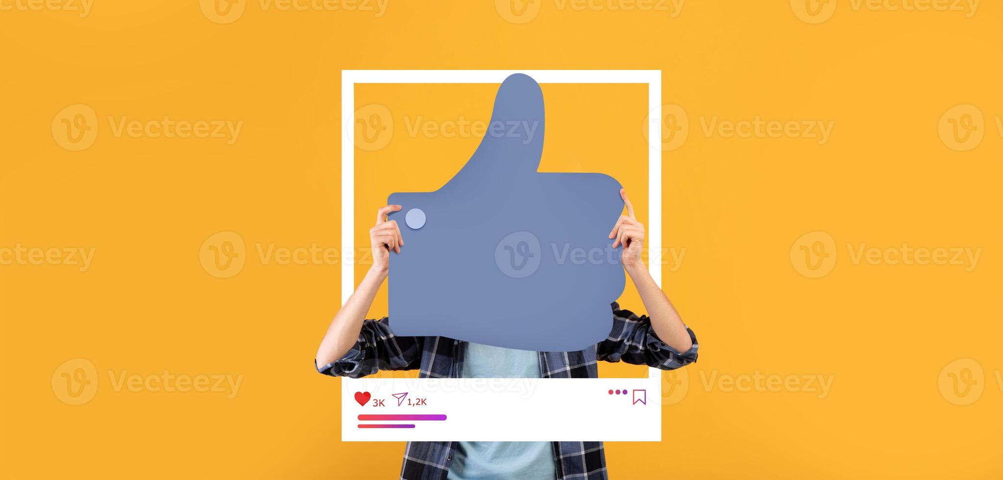 A person holds a large thumbs up symbol in front of their face against a vibrant yellow backdrop. This represents online engagement and positive feedback in social media and blogging. photo