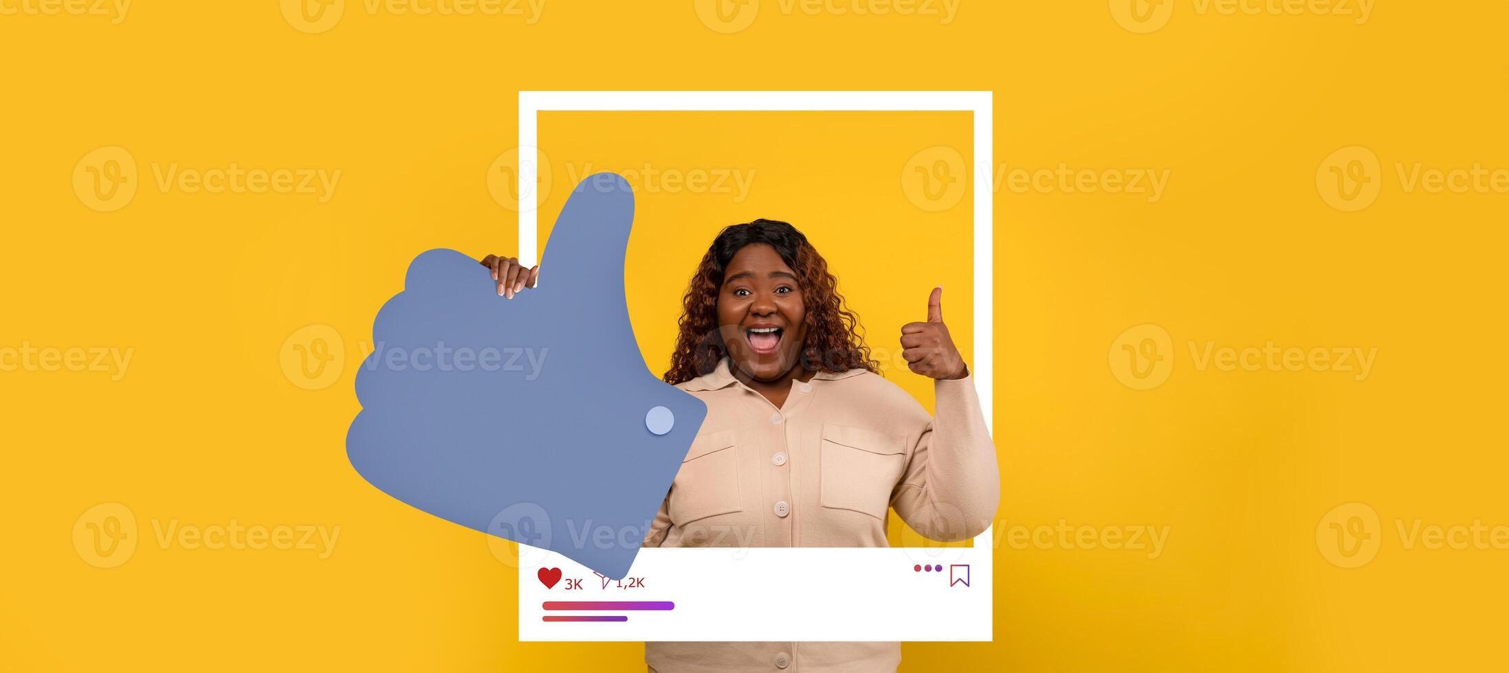 A cheerful influencer holds a large thumbs up sign against a bright yellow background, showcasing enthusiasm for online engagement and content sharing in a creative environment. photo