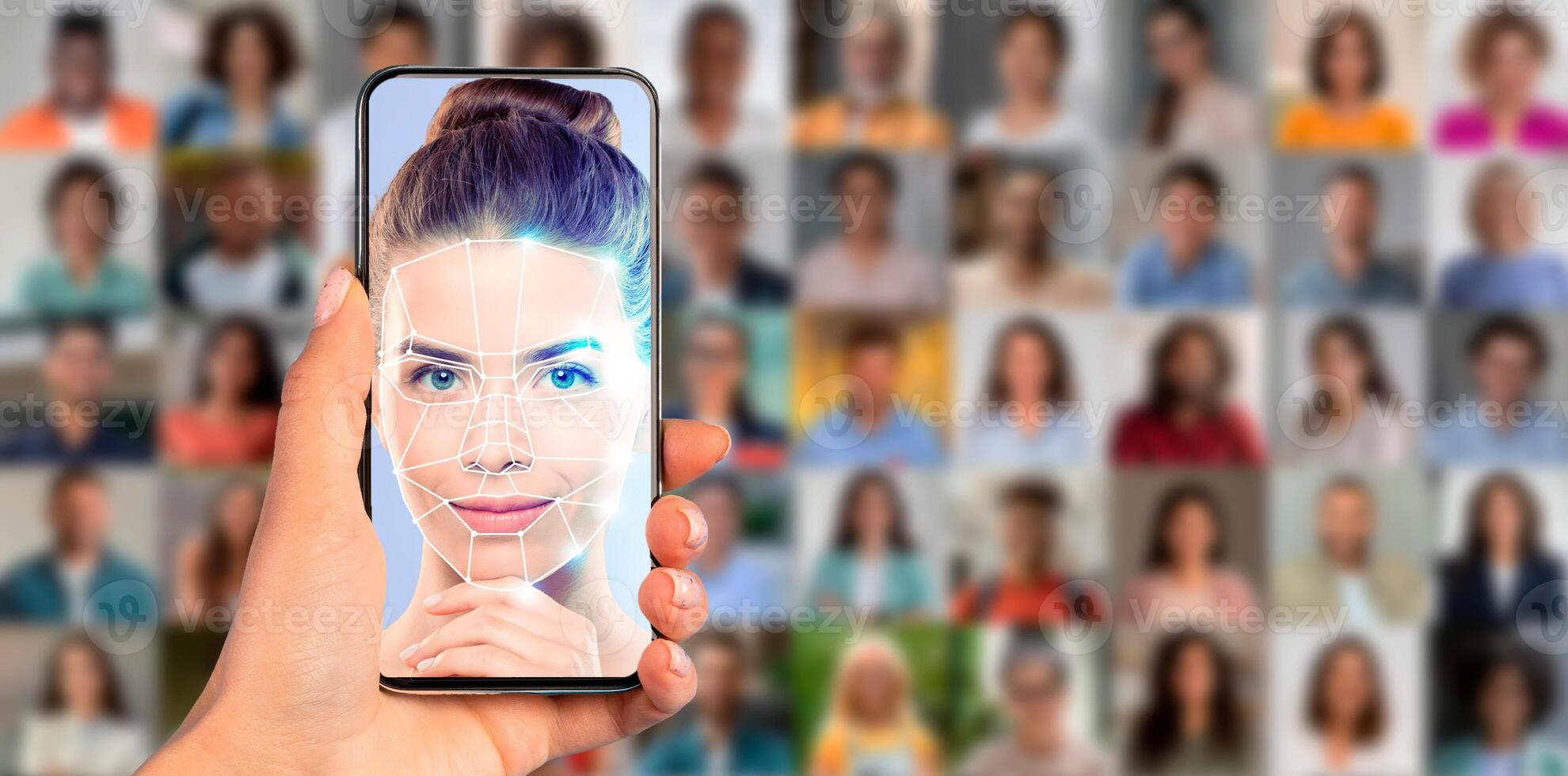 A person holds a smartphone displaying a facial recognition scan. The screen shows a detailed facial analysis of a young woman surrounded by a collage of diverse faces in the background. photo