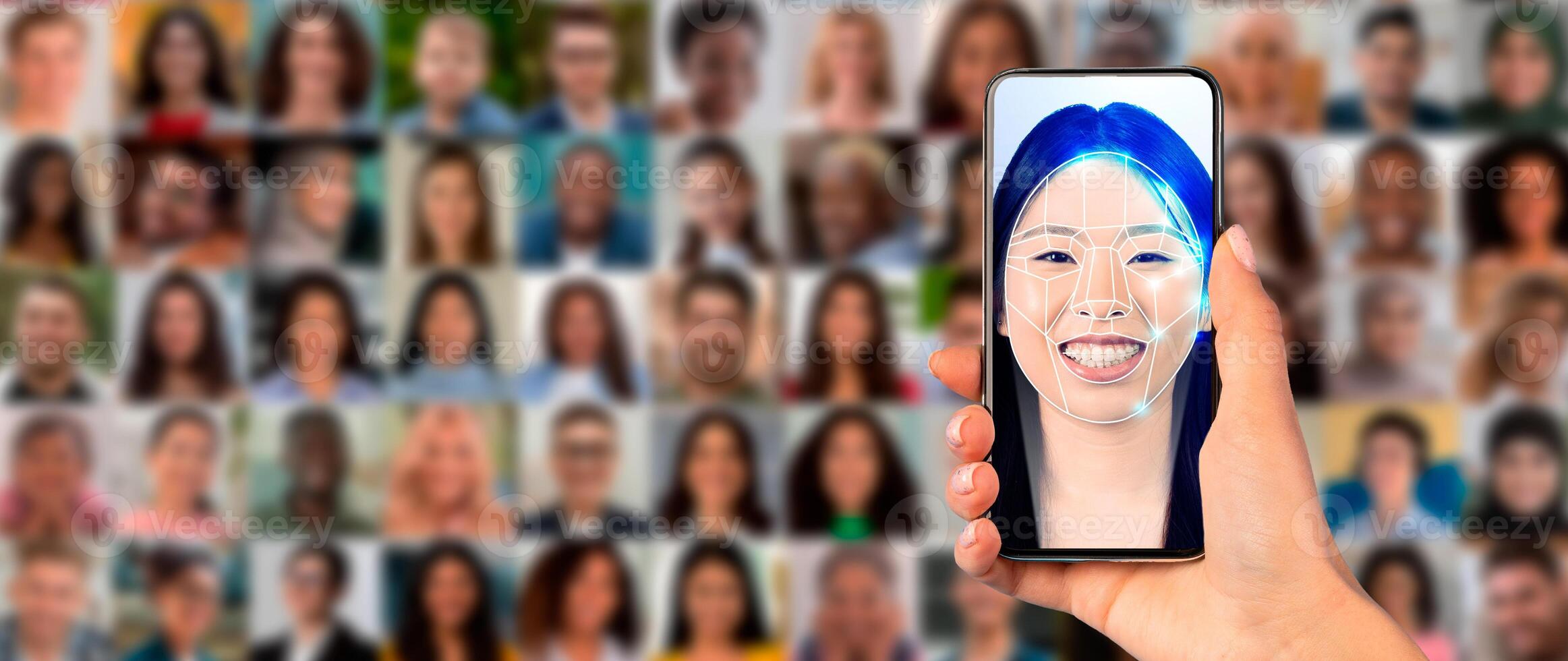 A hand holds a smartphone showing a face scan with a smiling individual. In the background, a collage of diverse faces represents modern identification technology in action. photo