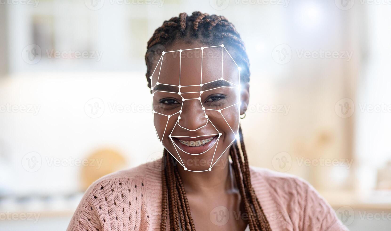 African American young woman smiles as facial recognition technology identifies her in a cozy indoor environment. This scene highlights the increasing use of modern techniques for identification. photo