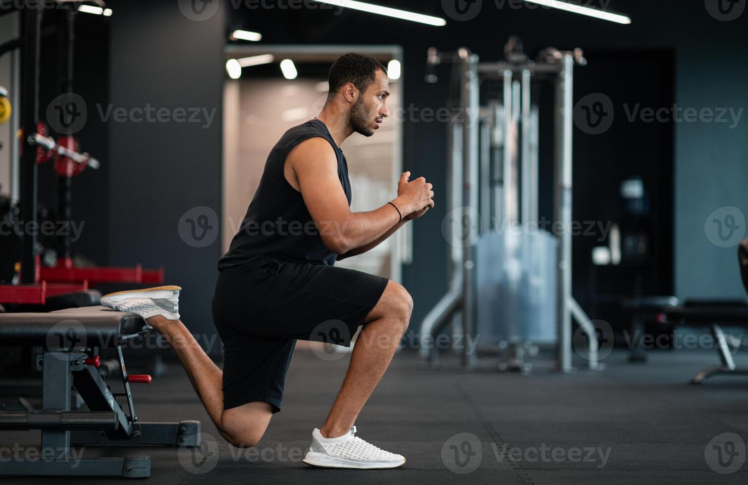 Portrait Of Athletic Black Man Making Bulgarian Split Squat Exercise At Gym, Motivated Young African American Male Training On Leg Muscles At Modern Sport Club, Enjoying Bodybuilding, Side View photo