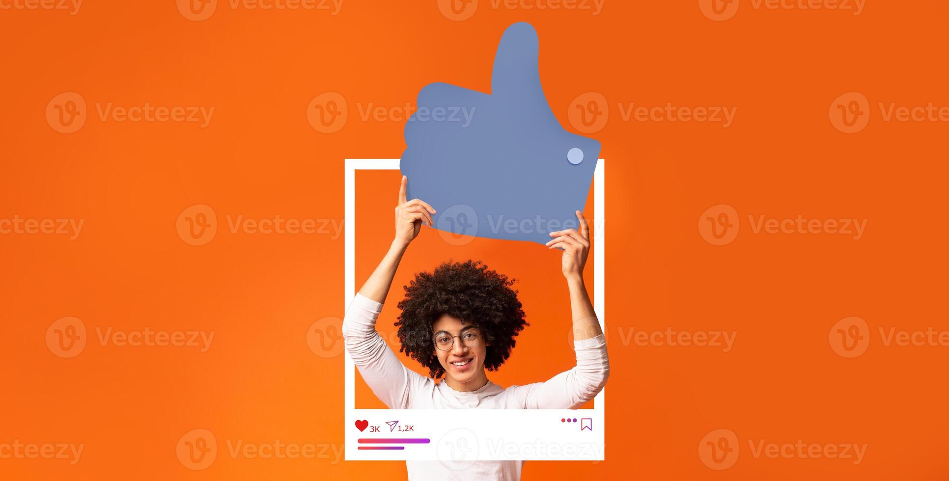 A joyful influencer is holding a large thumbs up sign against a bright orange background. This engaging display highlights the positive aspects of social media interaction and content creation. photo
