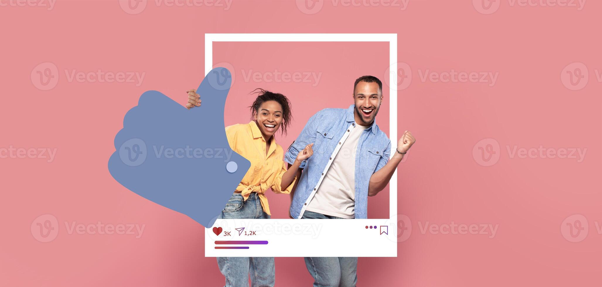 Two individuals pose joyfully in a playful manner, giving thumbs up with a vibrant pink backdrop. Their expressions reflect excitement, capturing a moment of celebration and connection online. photo