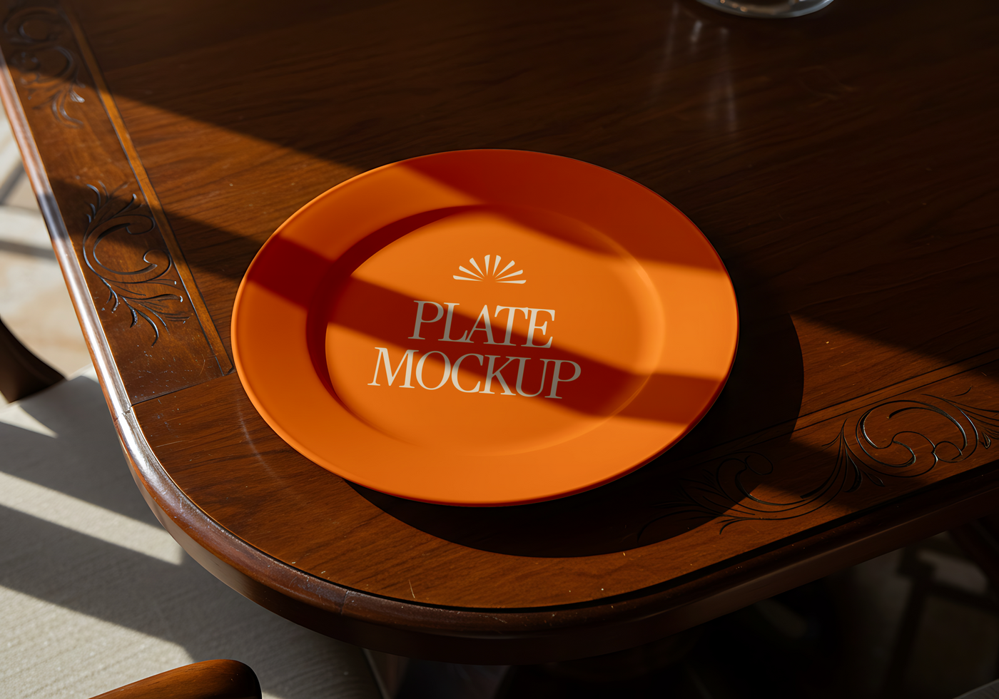 An orange plate with Plate Mockup printed on it sits on a dark wood table psd