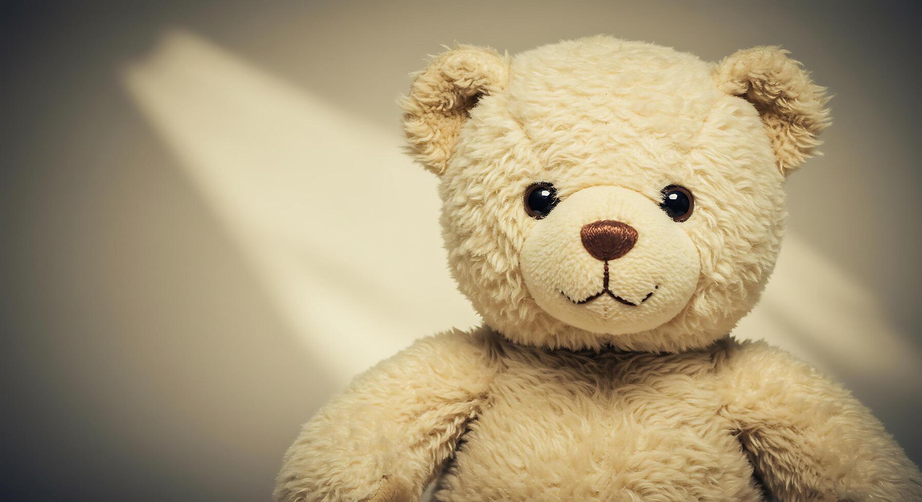 A teddy bear is sitting on a table photo