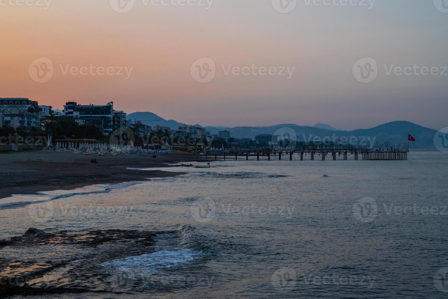 Beautiful sunrise scene on Alanya beach with view to famous Alanya island, in Turkey photo