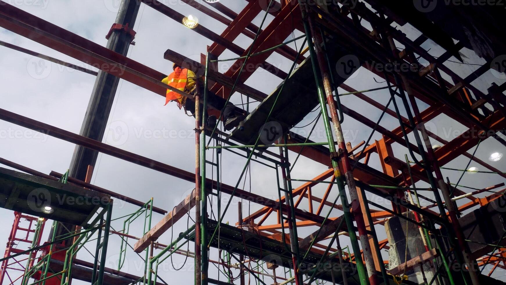 Construction Site with Steel Framework and Scaffolding Under Cloudy Sky, Highlighting Industrial Progress and Urban Development photo