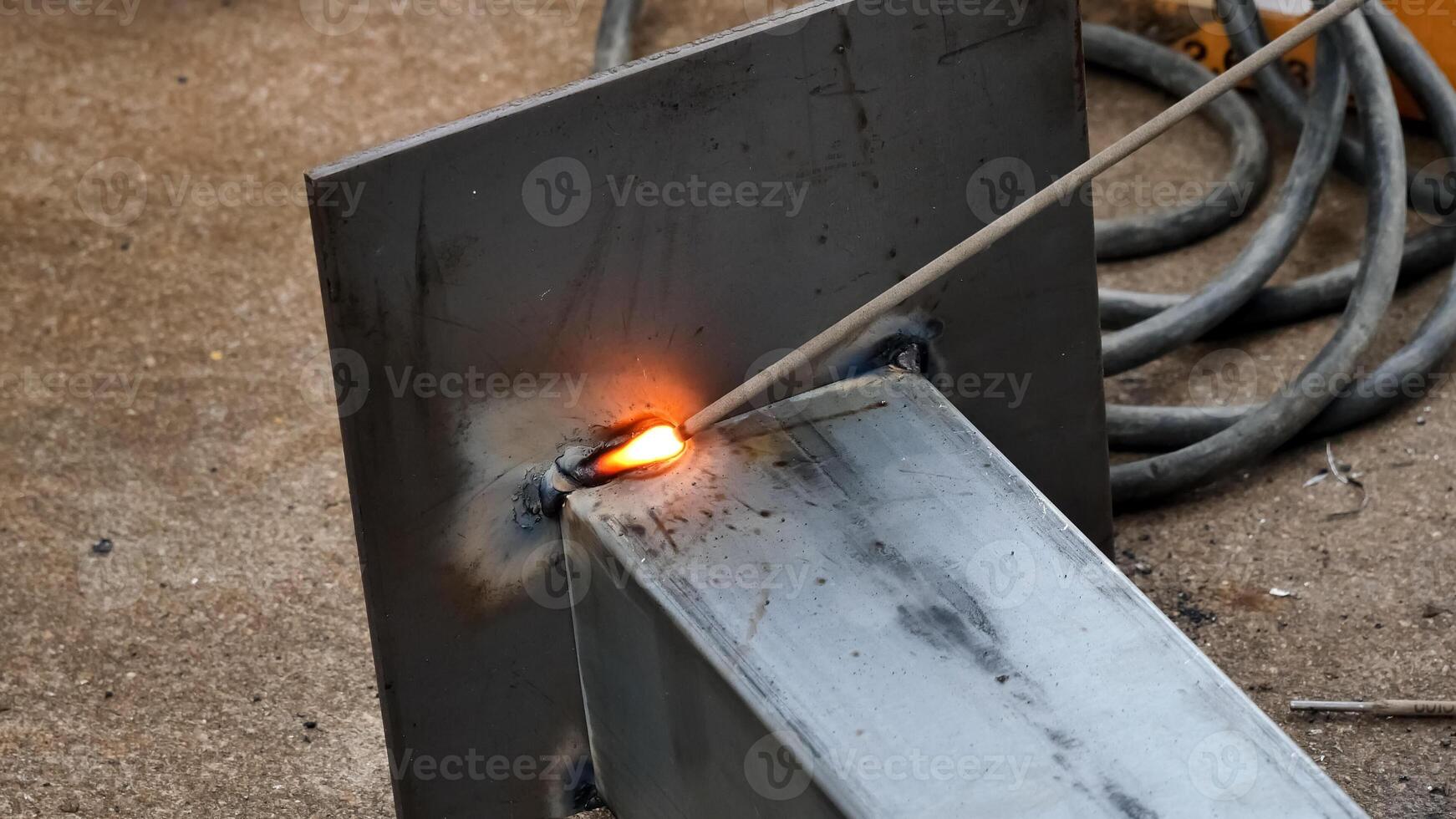 Close-Up of Welding Process with Bright Sparks and Metalwork in Industrial Setting photo