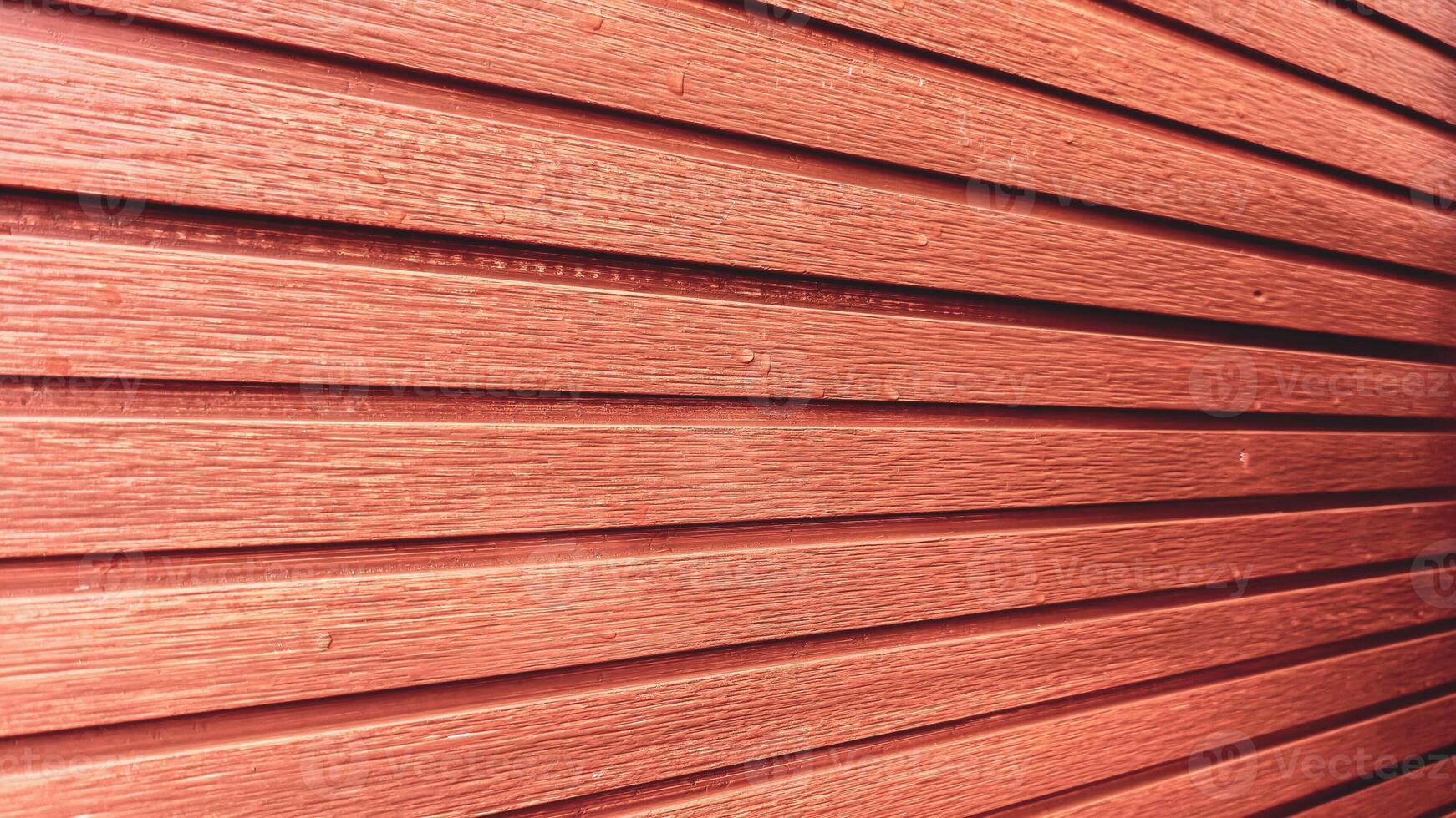 Close-Up of Red Wooden Wall with Horizontal Planks Creating a Textured and Rustic Architectural Background photo