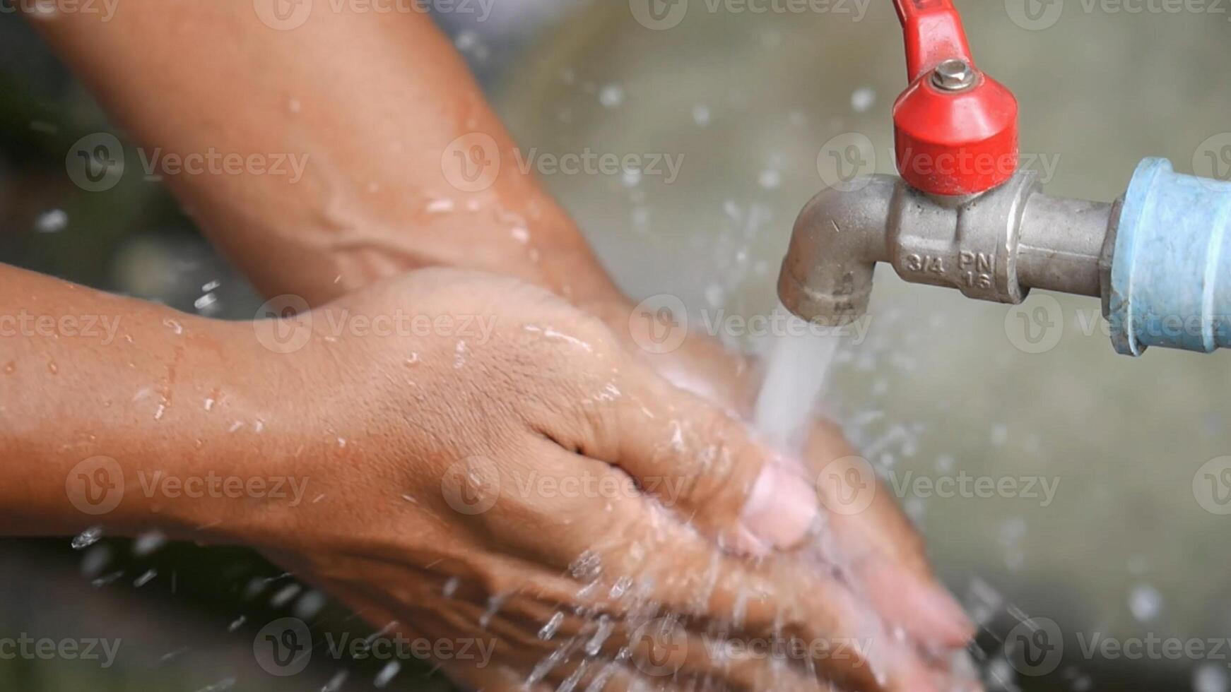 Hands Washing Under Running Water from Outdoor Faucet for Hygiene and Cleanliness Concept photo