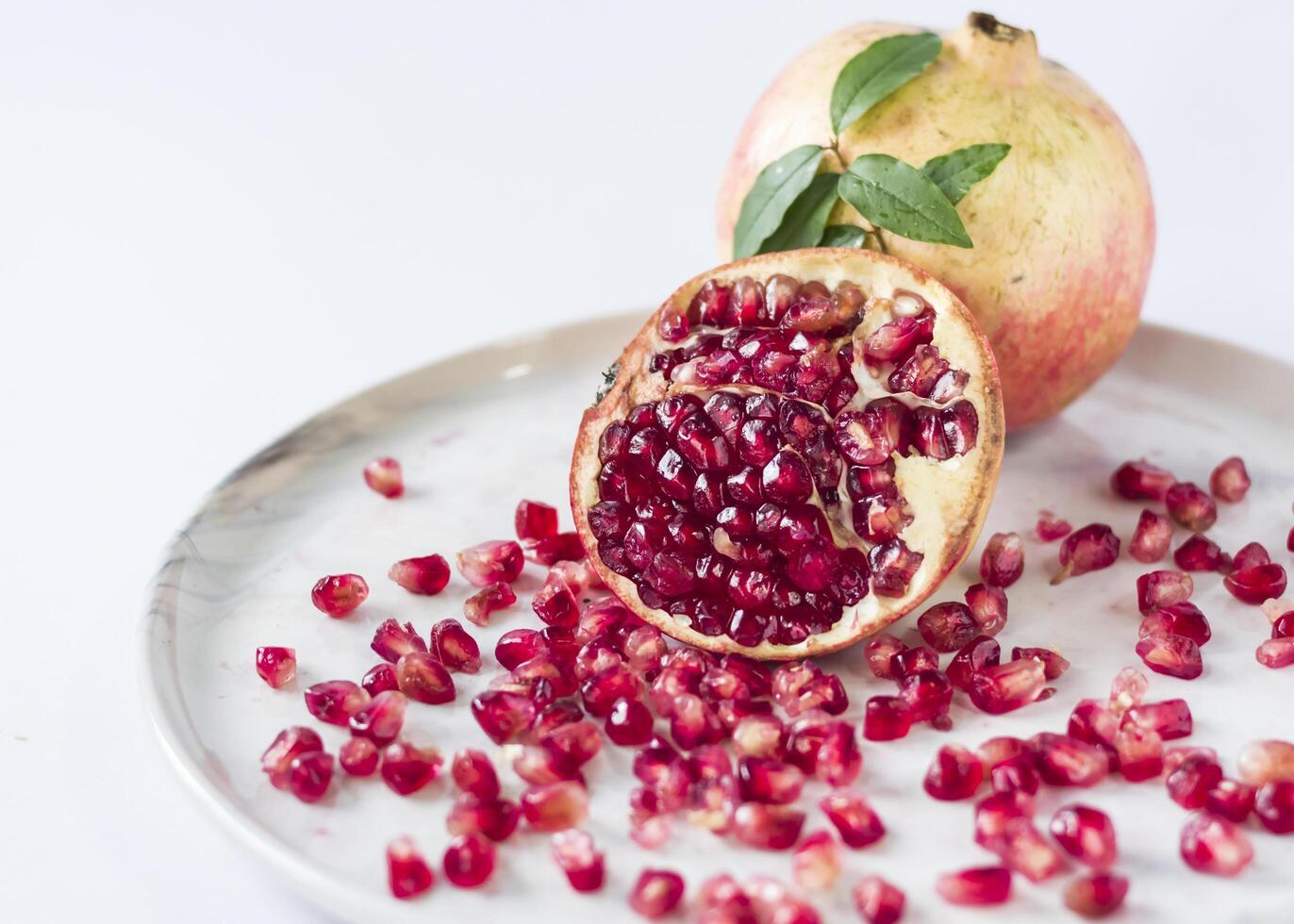 a pomegranate is cut in half and sitting on a plate photo